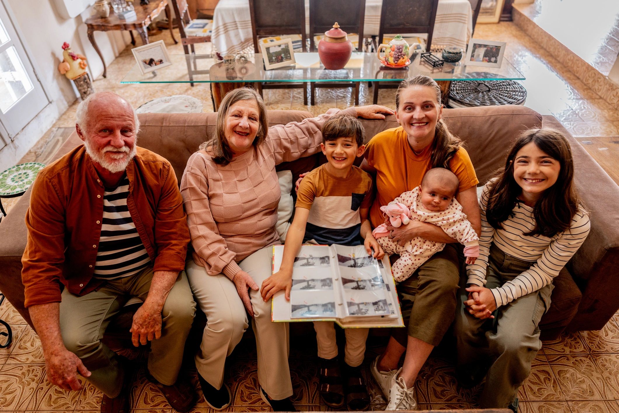 Family gathered around a photo album