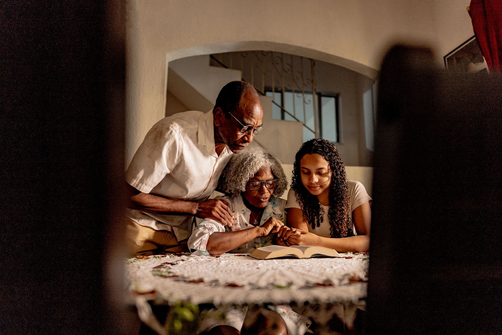 Family gathered reading together at home
